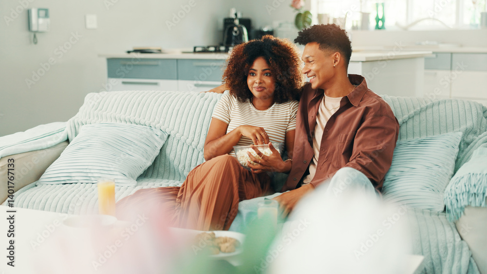 Couple, watching tv and popcorn at home with movies, series and affection. Man, woman and living room sofa for bonding, streaming online or snacks with subscription package for entertainment in house Couple, watching tv and popcorn at home with movies, series and affection. Man, woman and living room sofa for bonding, streaming online or snacks with subscription package for entertainment in house