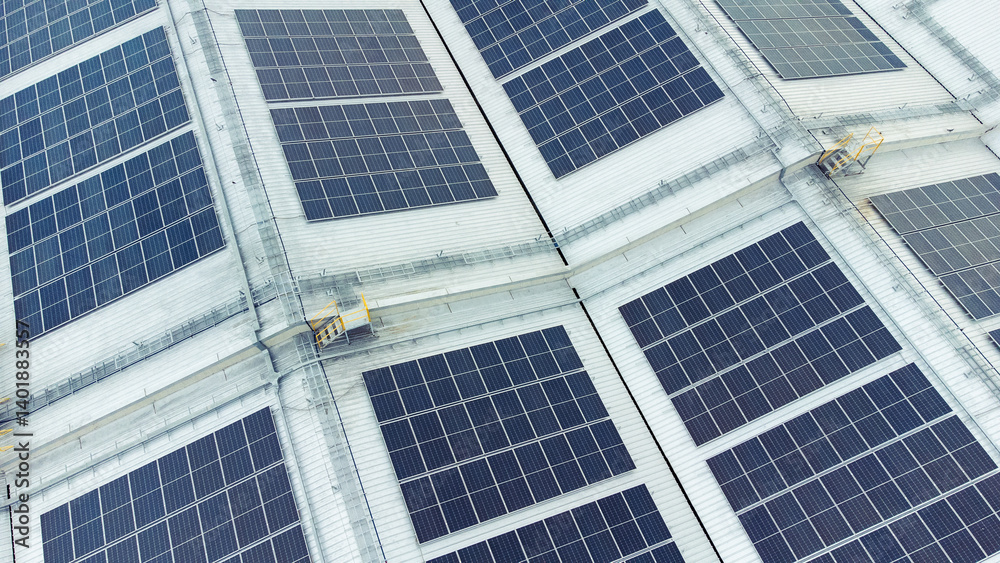 multiple solar panels installed on the rooftop of a building. The solar panels are arranged in neat rows and columns, with clear separations between each panel.
