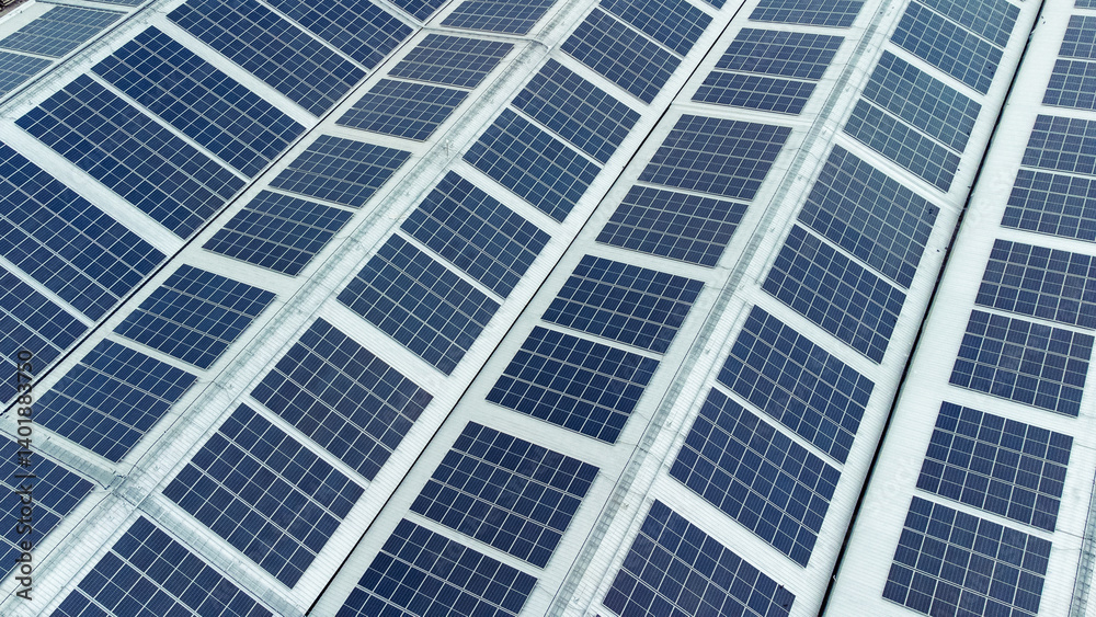multiple solar panels installed on the rooftop of a building. The solar panels are arranged in neat rows and columns, with clear separations between each panel.