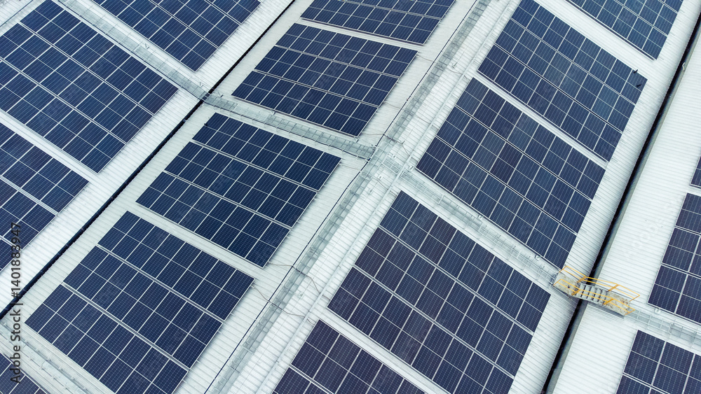 multiple solar panels installed on the rooftop of a building. The solar panels are arranged in neat rows and columns, with clear separations between each panel.