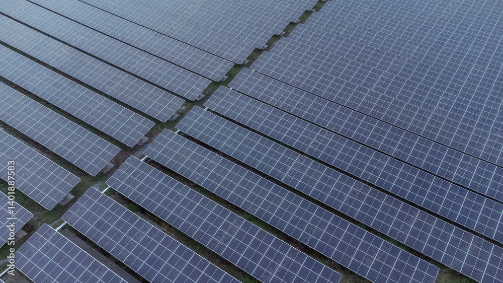 multiple solar panels installed on the rooftop of a building. The solar panels are arranged in neat rows and columns, with clear separations between each panel. multiple solar panels installed on the rooftop of a building. The solar panels are arranged in neat rows and columns, with clear separations between each panel.