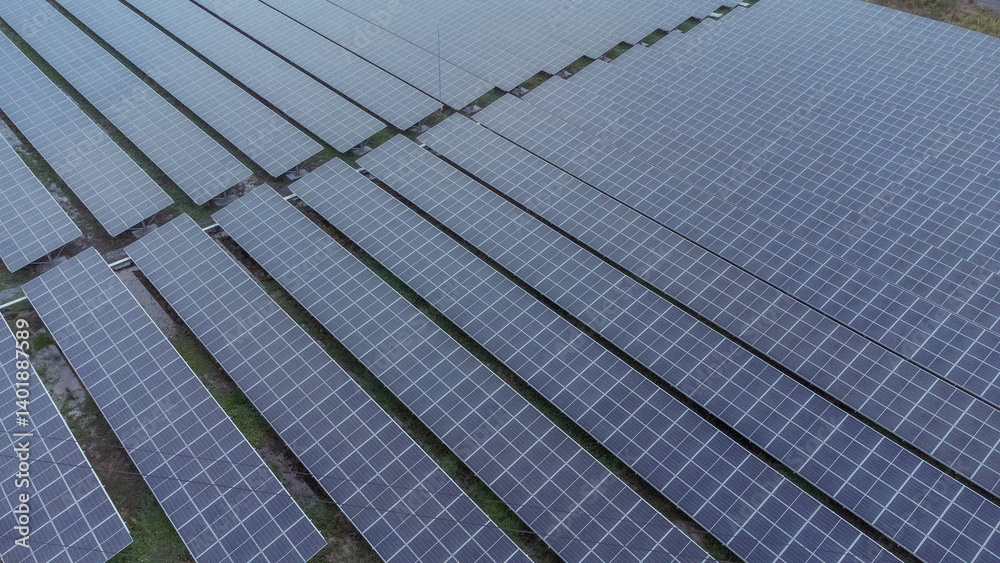 multiple solar panels installed on the rooftop of a building. The solar panels are arranged in neat rows and columns, with clear separations between each panel. multiple solar panels installed on the rooftop of a building. The solar panels are arranged in neat rows and columns, with clear separations between each panel.