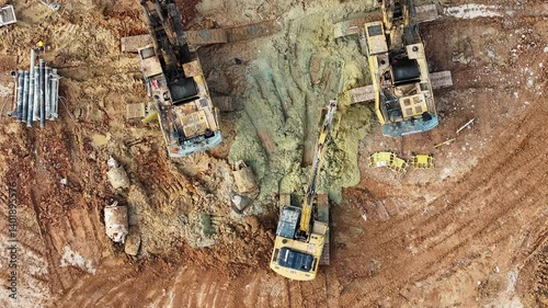 Aerial top view of the construction site at the initial stage of construction and heavy construction machine with a pile driver,excavator,rotary drill 