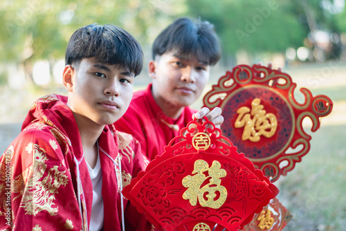 Happy Chinese new year, Chinese boys hold red carp lantern and Chinese greeting cards meant to wish happiness on the occasion of the annual Chinese New Year. photo