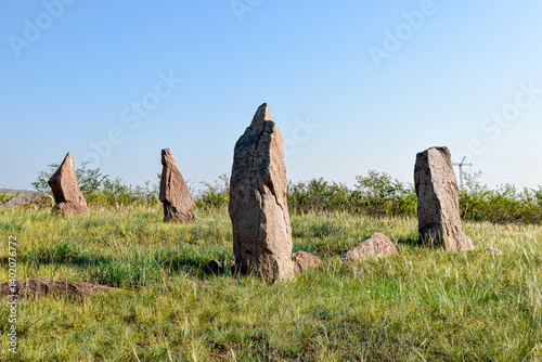 Khakassia. Old stone wall. Mountain landscape with blue sky