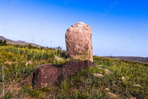 Khakassia. Old stone wall. Mountain landscape with blue sky