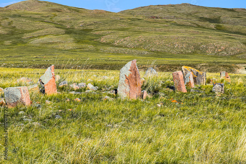 Khakassia. Old stone wall. Mountain landscape with blue sky