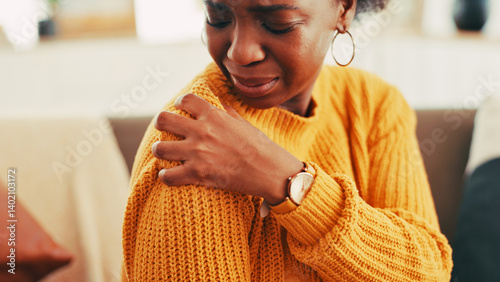 Obraz na płótnie Hands, woman and shoulder pain on couch at house for discomfort, joint inflammation and fibromyalgia. African person, cramps and muscle tension of arthritis, posture injury and strain of arm fracture w salonie