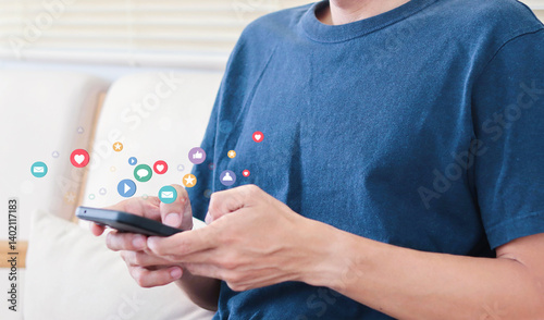 Social media concept. Young man using his mobile for check new suggestion or interact with people by replying chat for responding feeling and idea.