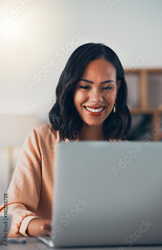 African woman working on laptop, networking on social media online and browsing internet while sitting in an office alone at work. Smiling and cheerful female manager planning and creating a strategy