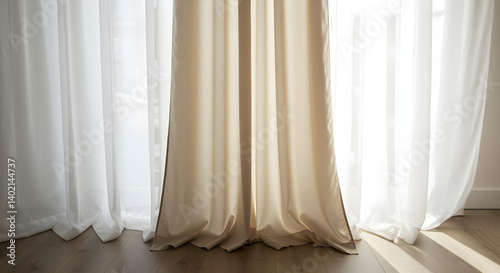 The sun gently illuminates a room  highlighting beige and white curtains near a window.