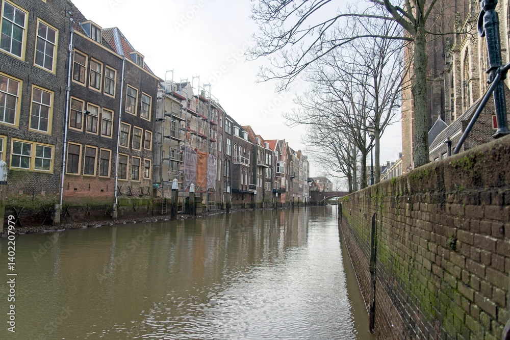 Fototapeta premium Dordrecht Netherlands - 27 January 2024 - Old warehouses at the Pottenkade next to the Grote Kerk in Dordrecht in the Netherlands