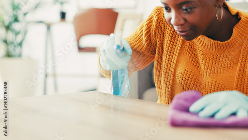Obraz na płótnie Housekeeping, spray bottle and black woman with cloth, cleaning and remove bacteria. Dust, apartment and African person in lounge, chore and routine with disinfectant, hygiene product or virus safety w salonie
