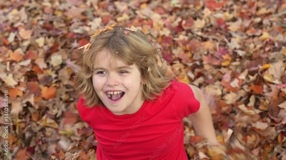 Autumn fall child mood. Little child in autumn orange leaves, outdoor portrait. Funny child face with autumn leaves in autumn park. Child playing with falling golden leaves. Outdoor portrait of kids. Autumn fall child mood. Little child in autumn orange leaves, outdoor portrait. Funny child face with autumn leaves in autumn park. Child playing with falling golden leaves. Outdoor portrait of kids.