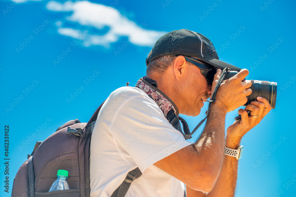 A caucasian male photographer during a National Park excursion