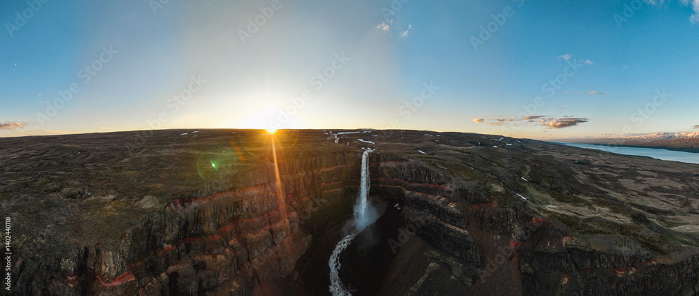 View from above, stunning panoramic view of the Hengifoss Waterfall. Hengifoss, is eye-catching due to the striking red clay and black basalt patterns of the cliff face. East Iceland.