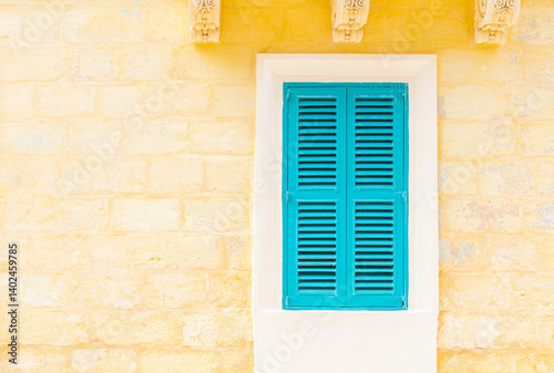 Obraz na płótnie Stone brick wall with a closed turquoise wooden window with shutters w salonie