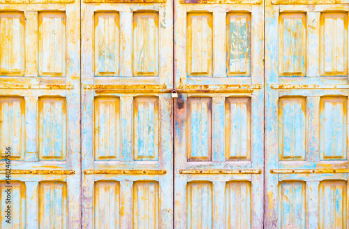 Locked old wooden garage doors with peeling paint