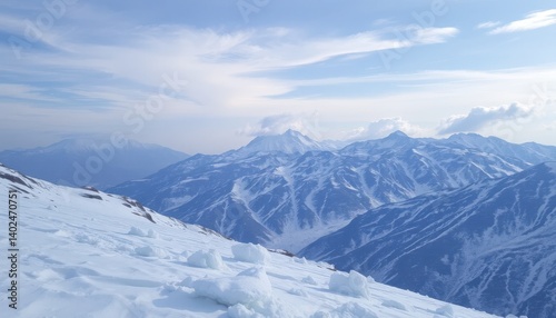 Wallpaper Mural A landscape view of snow covered mountains under a sky of light blue with some clouds. Torontodigital.ca
