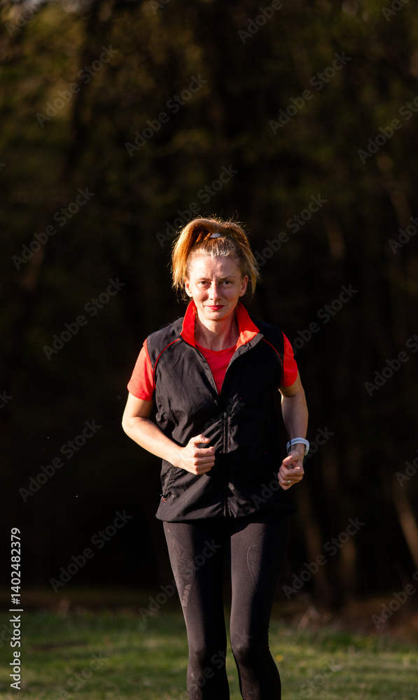 healthy fit woman in her forties running outdoors