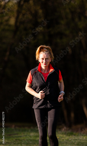 Obraz na płótnie healthy fit woman in her forties running outdoors w salonie