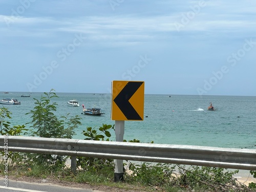 Road with chevron traffic signs in tropical Thailand