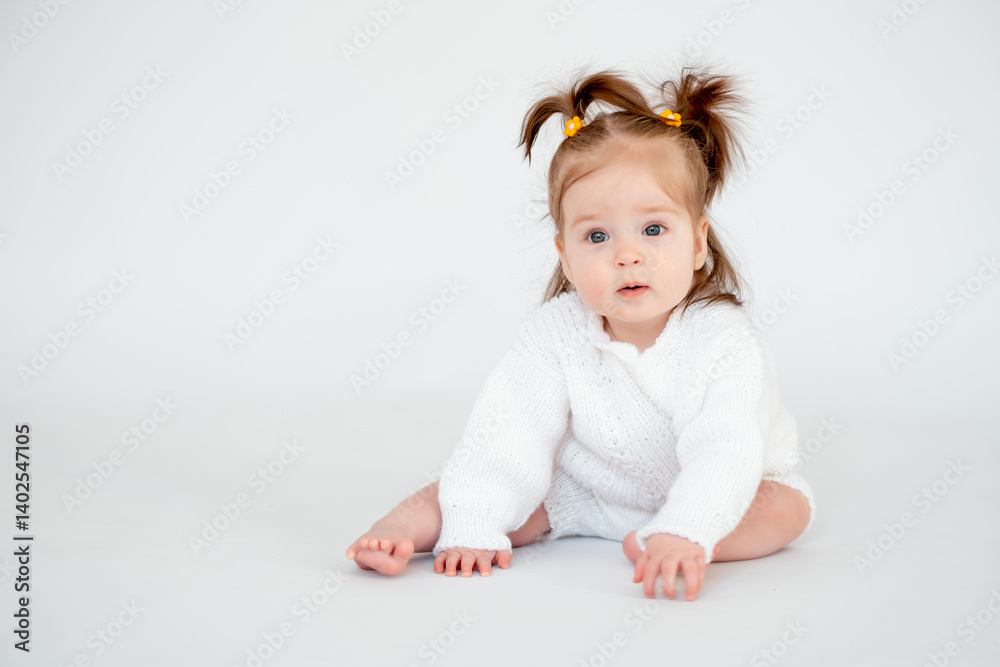 a baby girl on a white isolated background, a small child in a white knitted sweater smiling, a place for text a baby girl on a white isolated background, a small child in a white knitted sweater smiling, a place for text