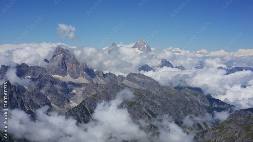 Vast mountain range with peaks obscured by clouds.