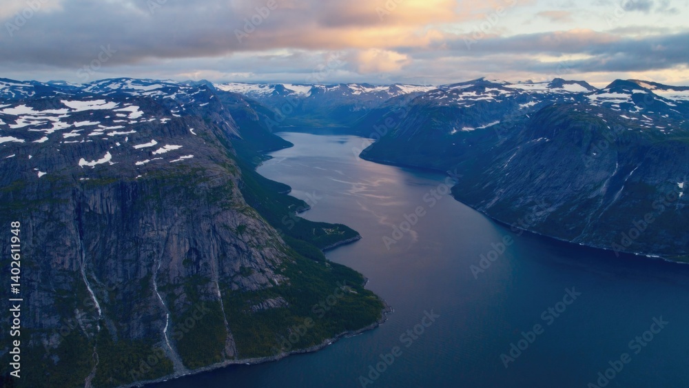 Waterway surrounded by snowy mountains.