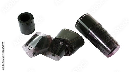 Multiple rolls of old black and white photographic film are arranged on a flat surface, showcasing their diverse textures and shapes. Nostalgic relics from the past tell stories of captured moments.