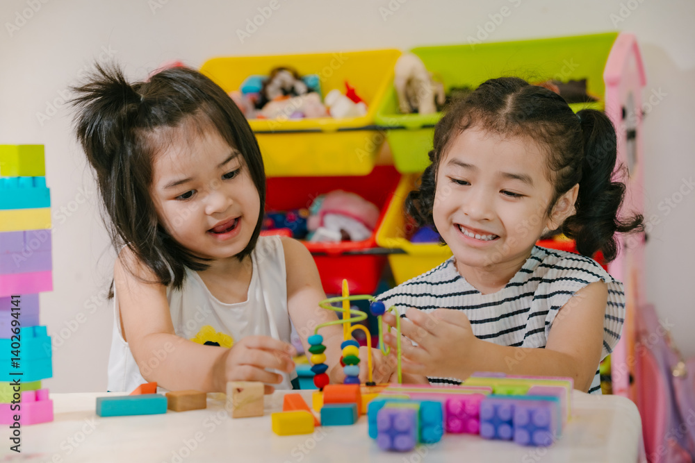 Fototapeta premium Girls happily play with developmental toys.