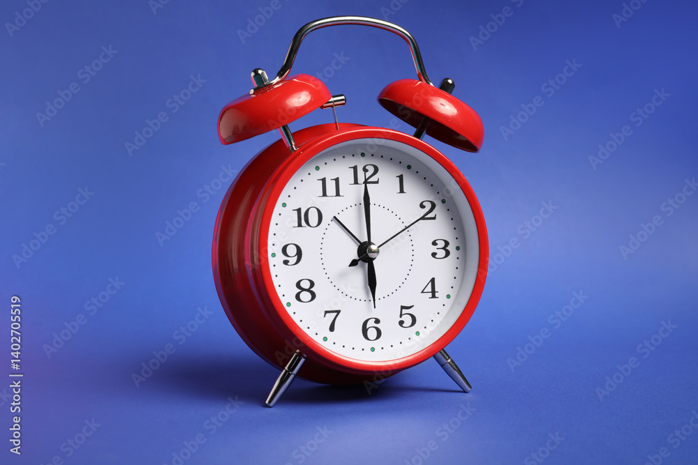 One red alarm clock on color background One red alarm clock on color background