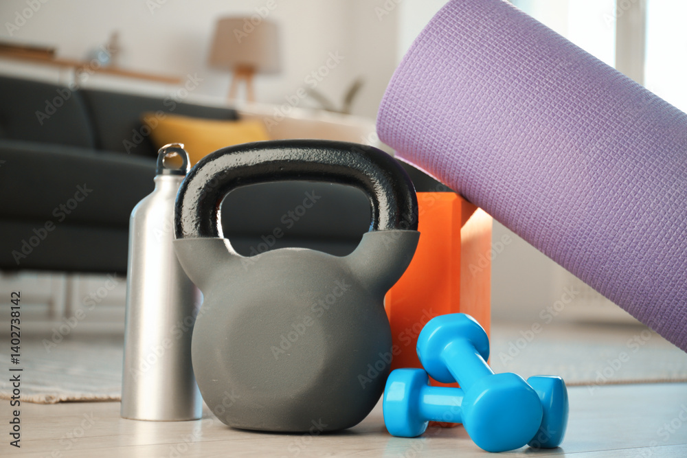 Different sports equipment on floor at home