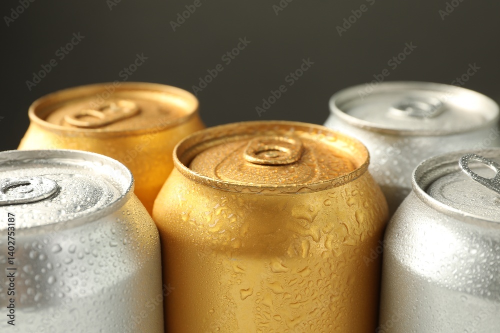 Many wet tin cans on grey background, closeup Many wet tin cans on grey background, closeup
