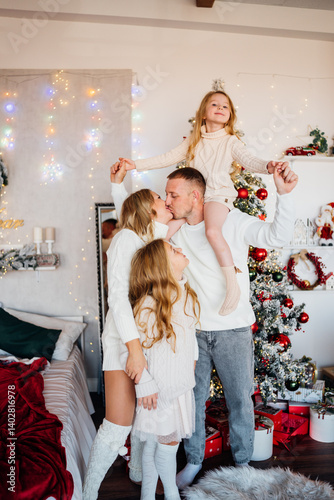 Obraz na płótnie A beautiful and happy family at the Christmas tree at home w salonie