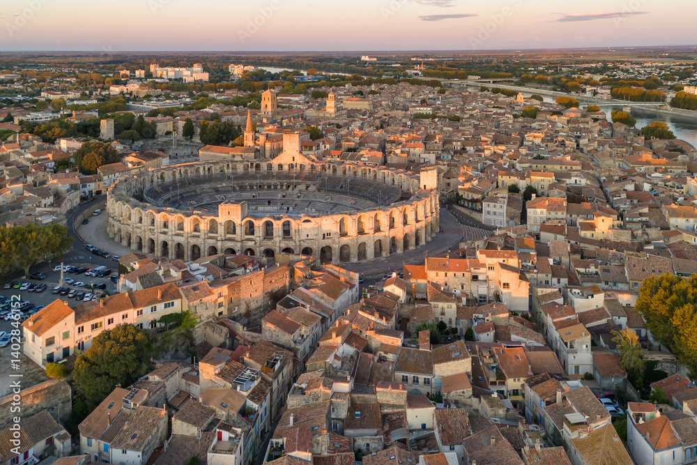 Fototapeta premium Aerial view of the Arles cityscape at sunrise, South of France