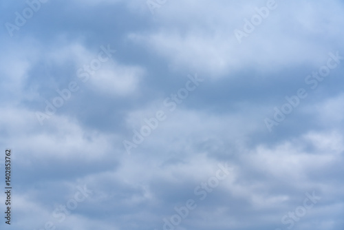 Cloudy sky with various shades of blue and gray covering the horizon
