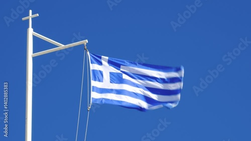 National flag of Greece flying in a strong breeze; photo taken at Chania on the island of Crete