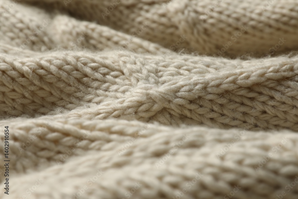 Beige knitted wool texture as background, closeup