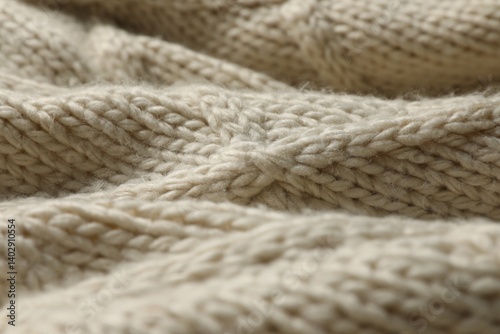 Beige knitted wool texture as background, closeup