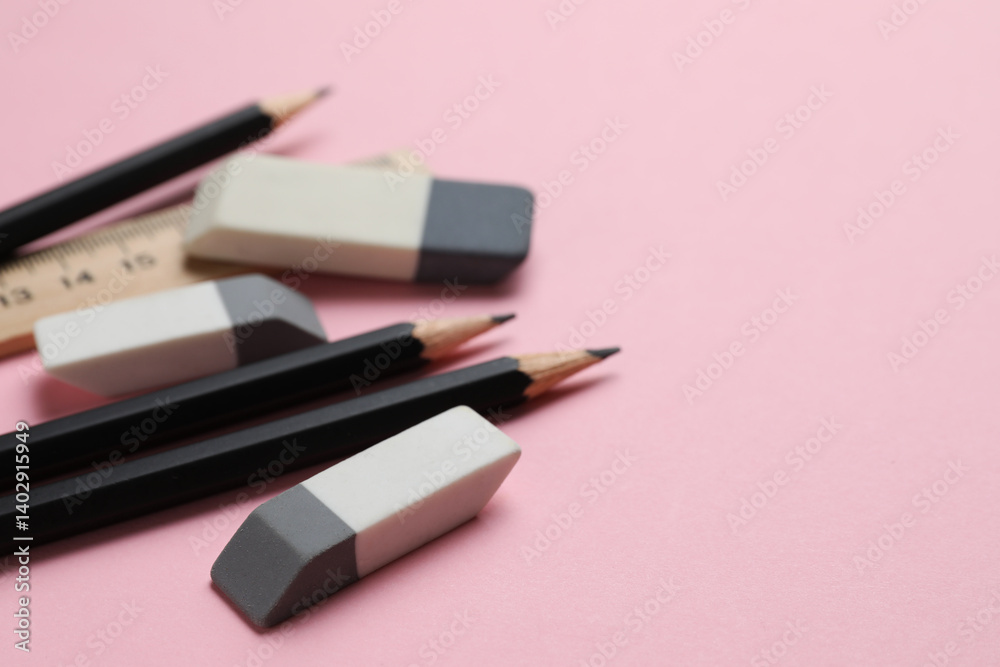 Erasers, ruler and pencils on pink background, closeup. Space for text Erasers, ruler and pencils on pink background, closeup. Space for text