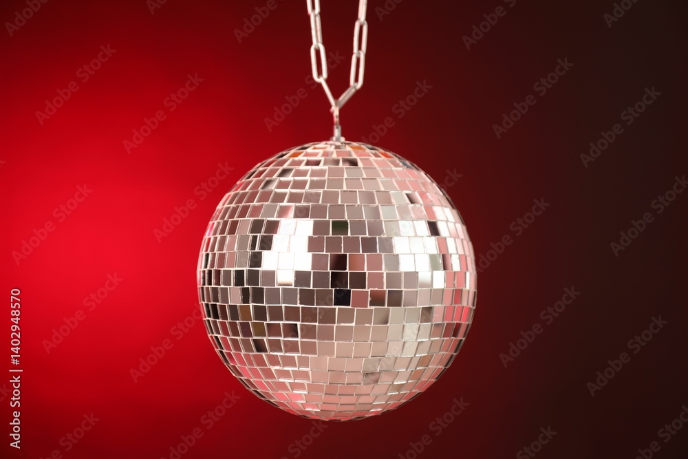 Obraz premium Shiny disco ball on red gradient background