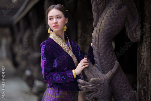 Pretty Asian women in traditional Thai dress. Beautiful conventional Thai dresses Lanna style. Fashion Thai dresses are popular with travellers in Chiang Mai, Thailand.