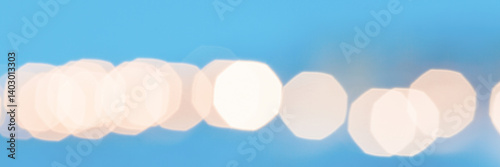 Obraz na płótnie Beautiful blurred festive background with bright highlights and bokeh. Shallow depth of field. Spectacular bright light spots on a blue background. Winter wide panoramic background for design. w salonie