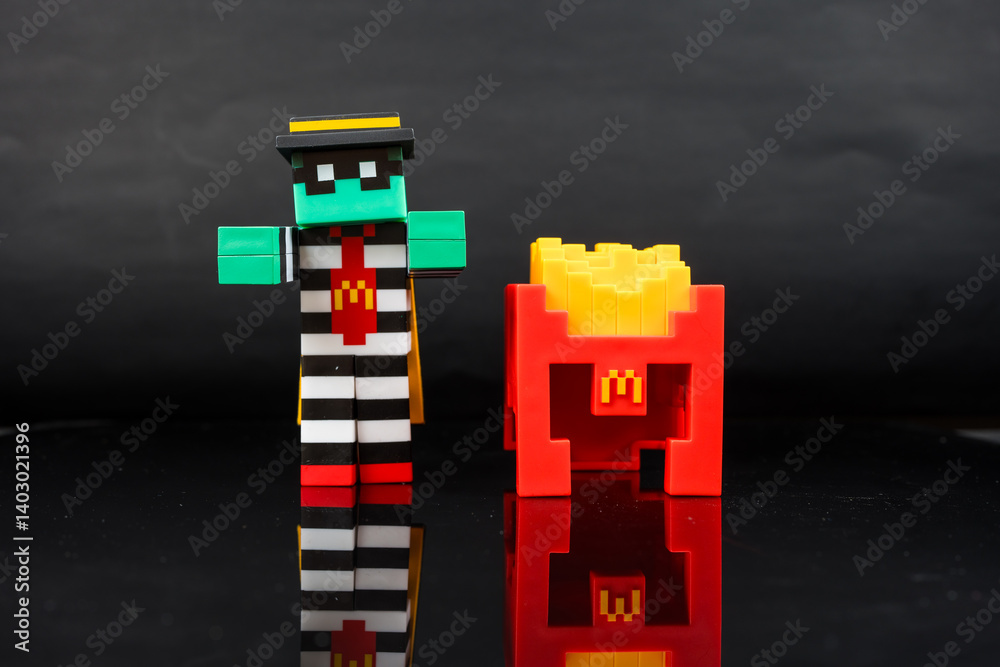 Fototapeta premium Bangkok, Thailand - April 6, 2025 : Zombie hamburglar and Minecraft fries helmet, Minecraft blind box from McDonald's collaborates.