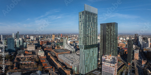 Картината върху платно Aerial view of Manchester, UK, featuring Deansgate Square towers, modern skyscrapers, historic brick buildings, and a grid like street layout