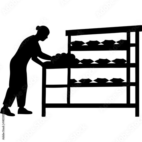 Baker Organizing Fresh Bread on Display Rack for Bakery Shop Use
