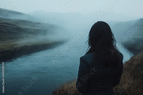 Misty Icelandic landscape viewed by a solitary figure.