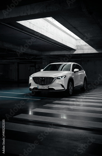 Photos White Mazda CX-9 in parking garage under light well