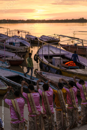 Wallpaper Mural On a beautiful morning in Varanasi, priests offer prayers by the Ganges River as boats rest gently on the water. Torontodigital.ca